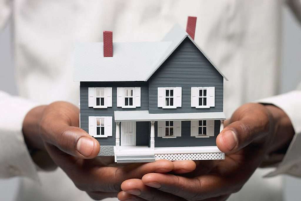 man-holding-a-wooden-house-image